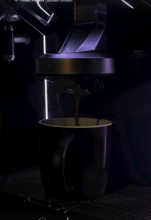 Fresh coffee pouring into a cup from the Trackspresso machine